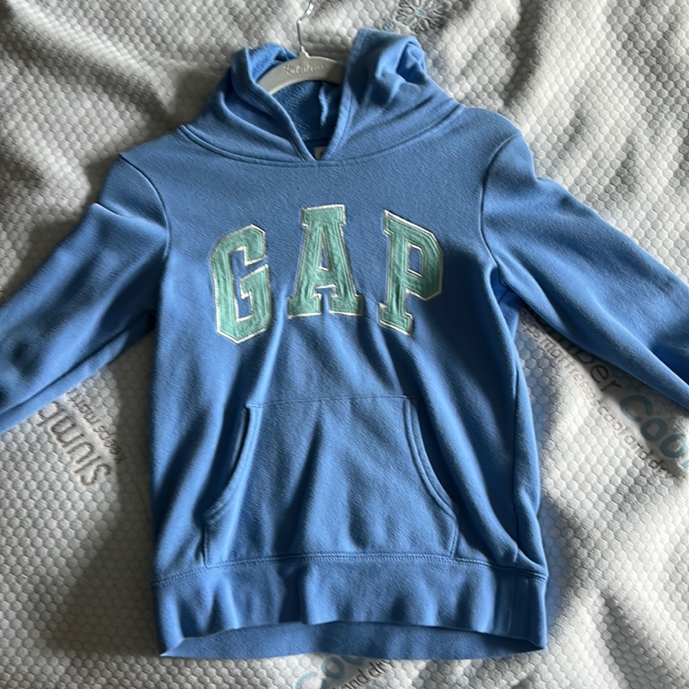 The color is a deep sky blue with a teal gap logo.